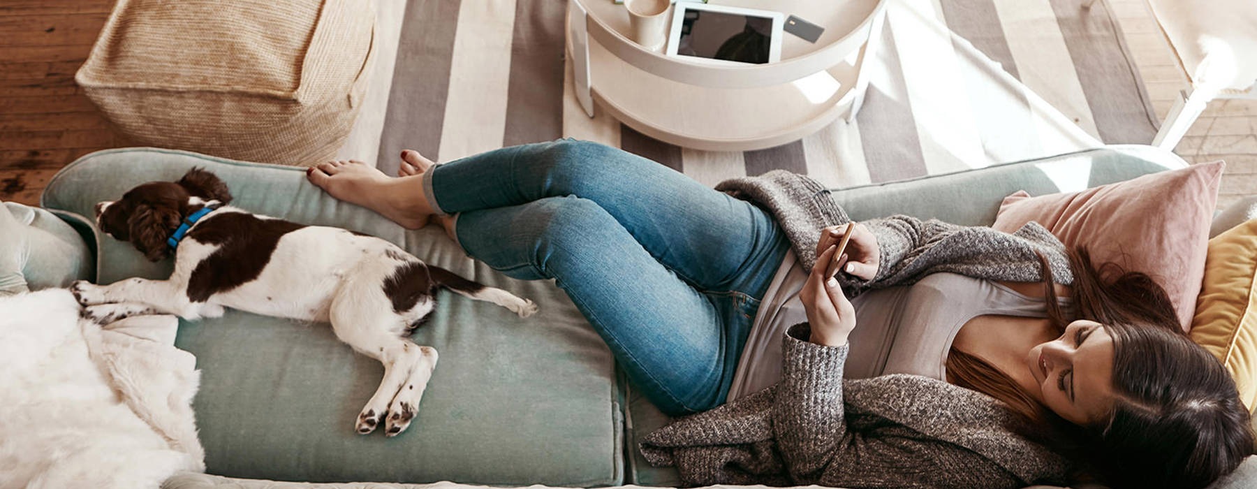 woman relaxing with dog on couch