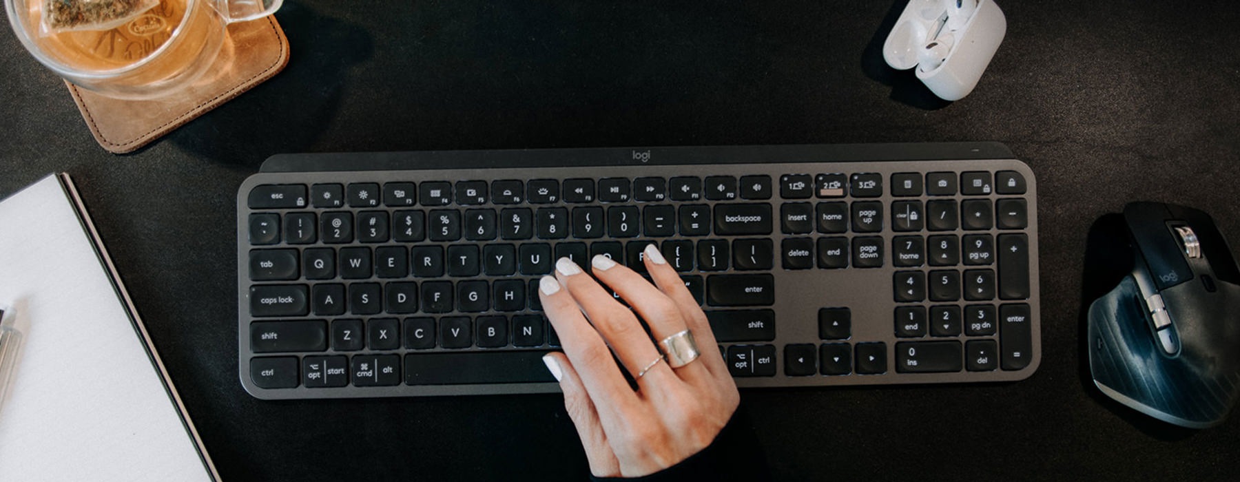 hand on keyboard with coffee and mouse close e